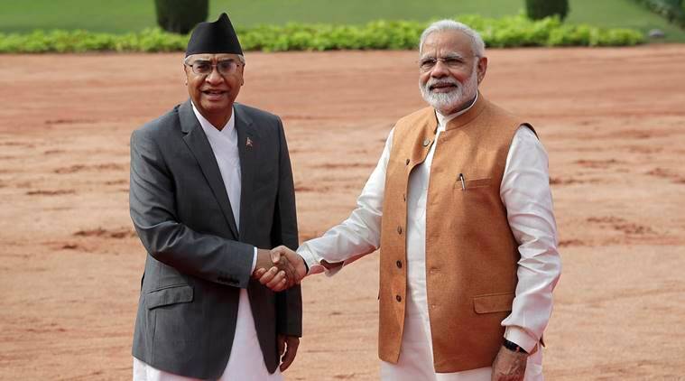 Prime Minister Narendra Modi, right, poses with his Nepalese counterpart Sher Bahadur Deuba for a photo in New Delhi, India. (Source: AP)