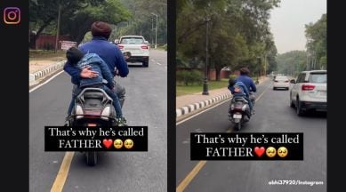 Dad prevents son from falling off the bike, wholesome father-son videos, viral videos father son, bike rider helps holds son to a bike seat, viral videos Instagram, indian express