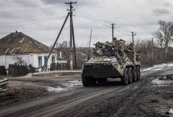Ukrainian servicemen ride an Armoured Personnel Carrier