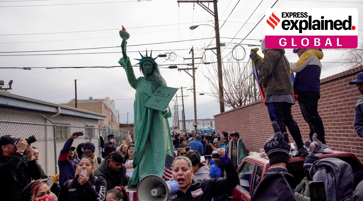 Protesters march to demand an end to the immigration policy called "Title 42" with small version of the Statue of Liberty.