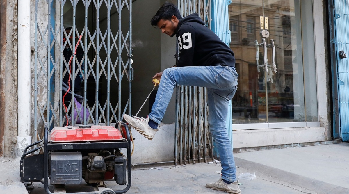A man starts a generator outside his shop during a country-wide power breakdown in Karachi, Pakistan January 23, 2023. (Reuters)