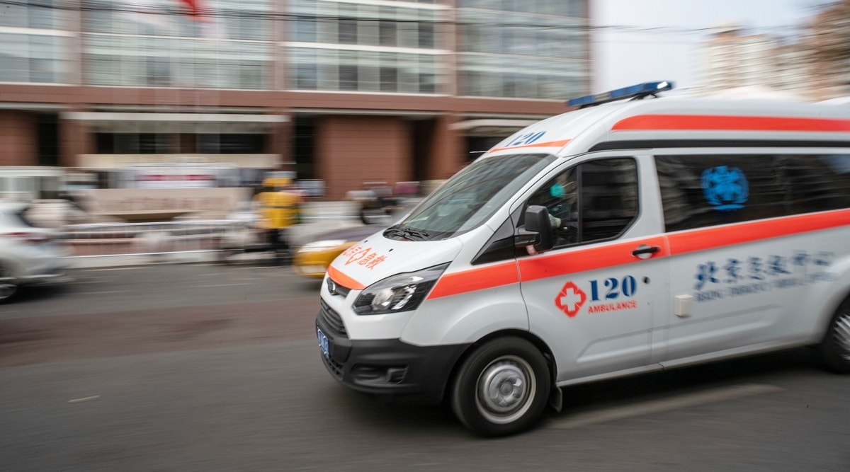 china ambulance drives through the road