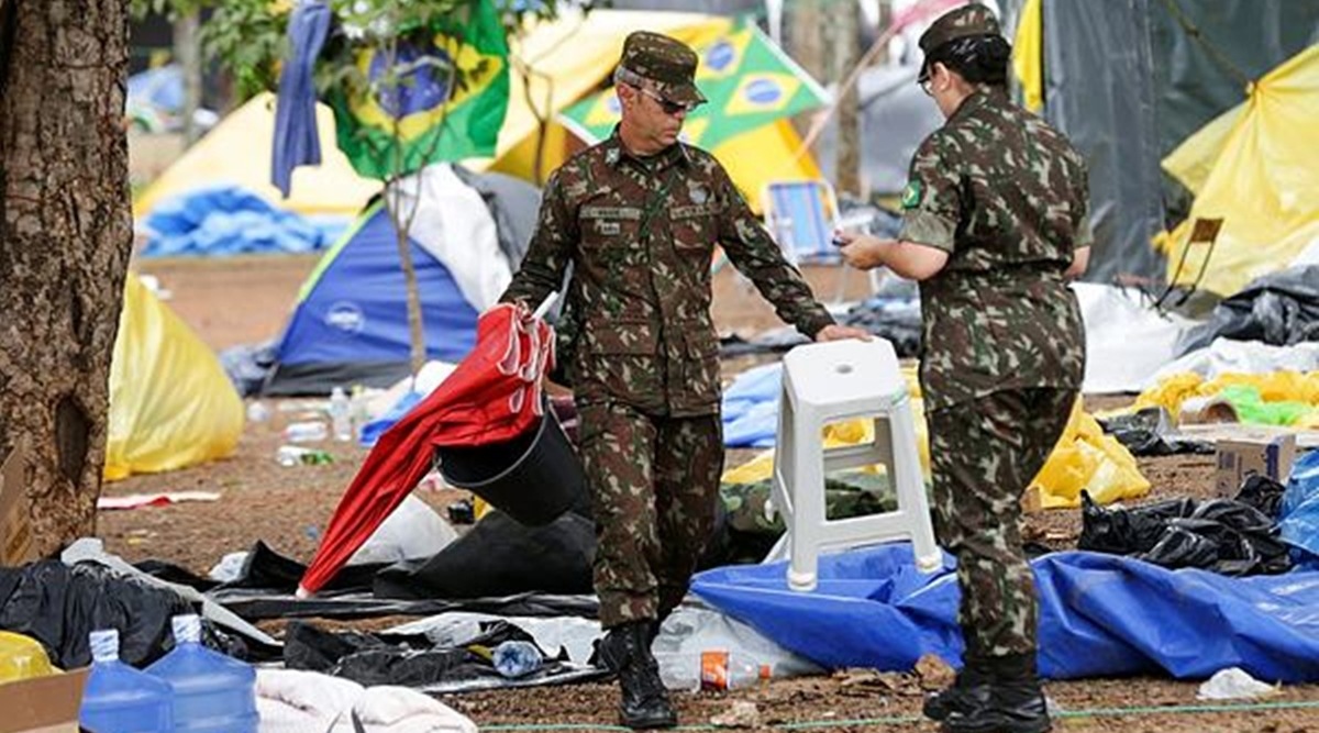 Soldiers help clear out an encampment set up by supporters of former Brazilian President Jair Bolsonaro outside army headquarters in Brasilia, Brazil. (AP Photo)