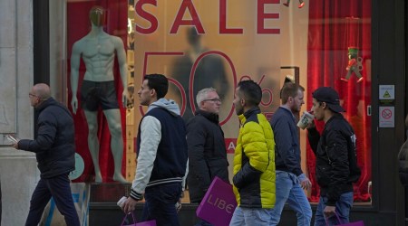 People walk along a street in a shopping district in central London, January 2, 2023. (AP)