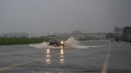 Cars drive through a flooded road in San Francisco on Dec 31, 2022. (Photo: The New York Times)