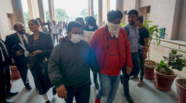 Gujarat ATS produces the 15 arrested for their alleged involvement in the exam question paper leak at a court in Vadodara on Monday. (Express photo by Bhupendra Rana)