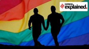 Two men running in front of a rainbow flag
