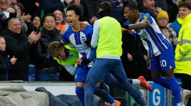 Brighton's Kaoru Mitoma, left, celebrates after scoring his side's second goal during the FA Cup 4th round soccer match between Brighton and Hove Albion and Liverpool at the Falmer Stadium in Brighton, England, Sunday, Jan. 29, 2023. (AP Photo/Alastair Grant)