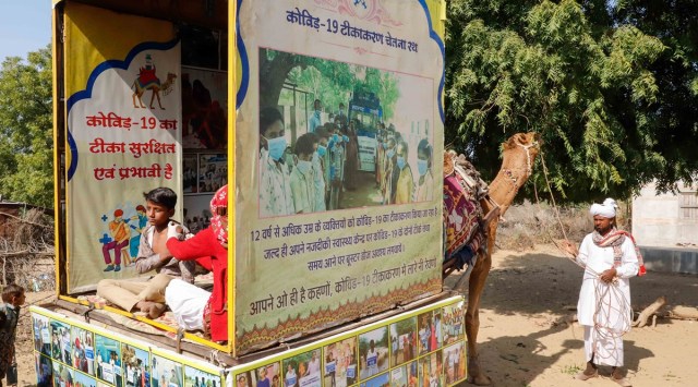 Health worker Chandravati administers a Covid vaccine shot inside a camel cart in Ramsar village of Rajasthan on 13 January 2023. (Express photo by Chitral Khambhati)