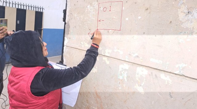 An enumerator puts the number on the first house as part of the casste survey in Patna's Bank Road on Saturday. Express