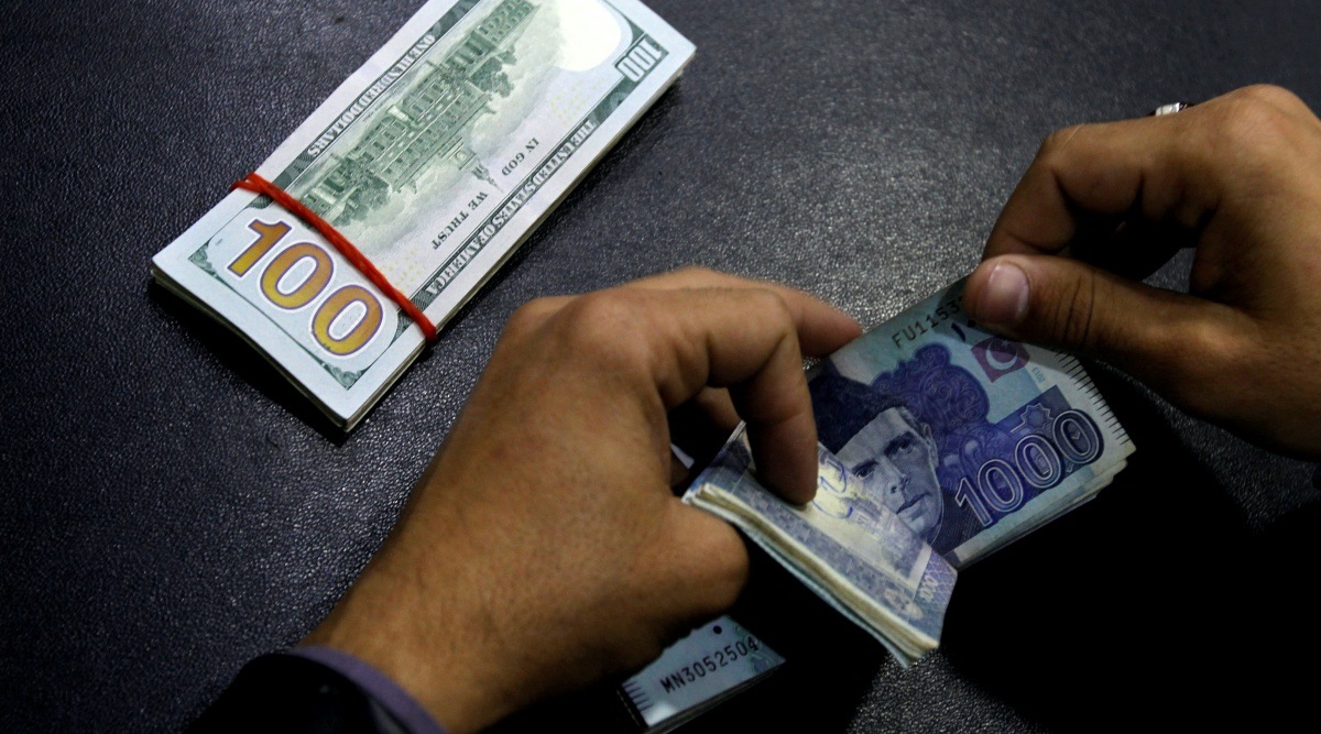 A currency trader counts Pakistani Rupee notes as he prepares an exchange of U.S dollars in Islamabad, Pakistan. (Reuters)