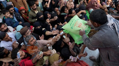 Pakistani people gather to buy subsidised sacks of flour from a sale point in Karachi, Pakistan, January 7, 2023. (AP/PTI)