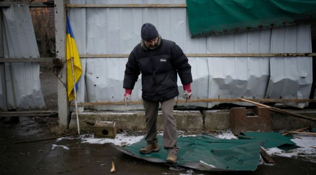 A man cleans following a rocket attack in Kyiv, Ukraine. (AP)
