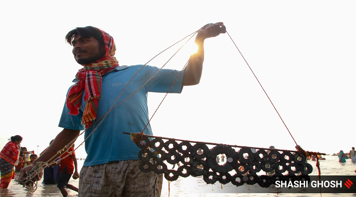 Locals fish coins from the sea in West Bengal’s Gangasagar; see pics ...