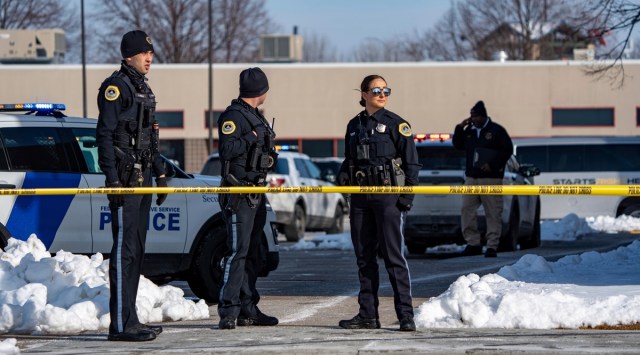 Law enforcement officers stand outside a school housing an educational programme called Starts Right Here that is affiliated with the Des Moines school district, following a shooting, January 23, 2023, in Des Moines, Iowa. (The Des Moines Register via AP)
