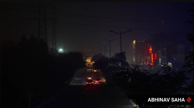 The dimly lit road stretch near Shaheen Bagh bus stand, with two-winged street lights. (Express Photo by Abhinav Saha)