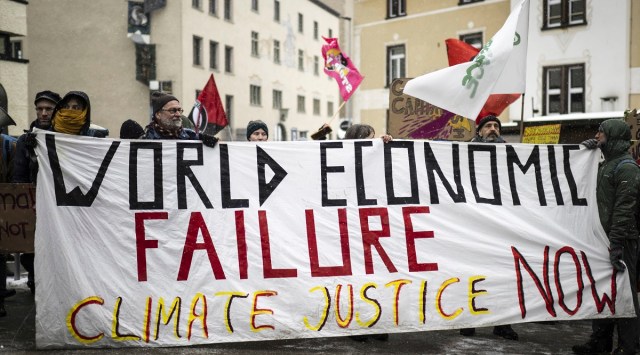 People attend a climate protest rally by Swiss party 'Juso' and the organization 'Strike WEF' on the eve of the 52nd annual meeting of the World Economic Forum (WEF) in Davos, Switzerland. (AP)