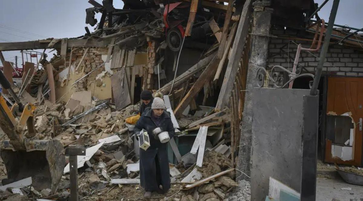 Local residents carry their belongings as they leave their home ruined in the Saturday Russian rocket attack in Zaporizhzhya (AP)