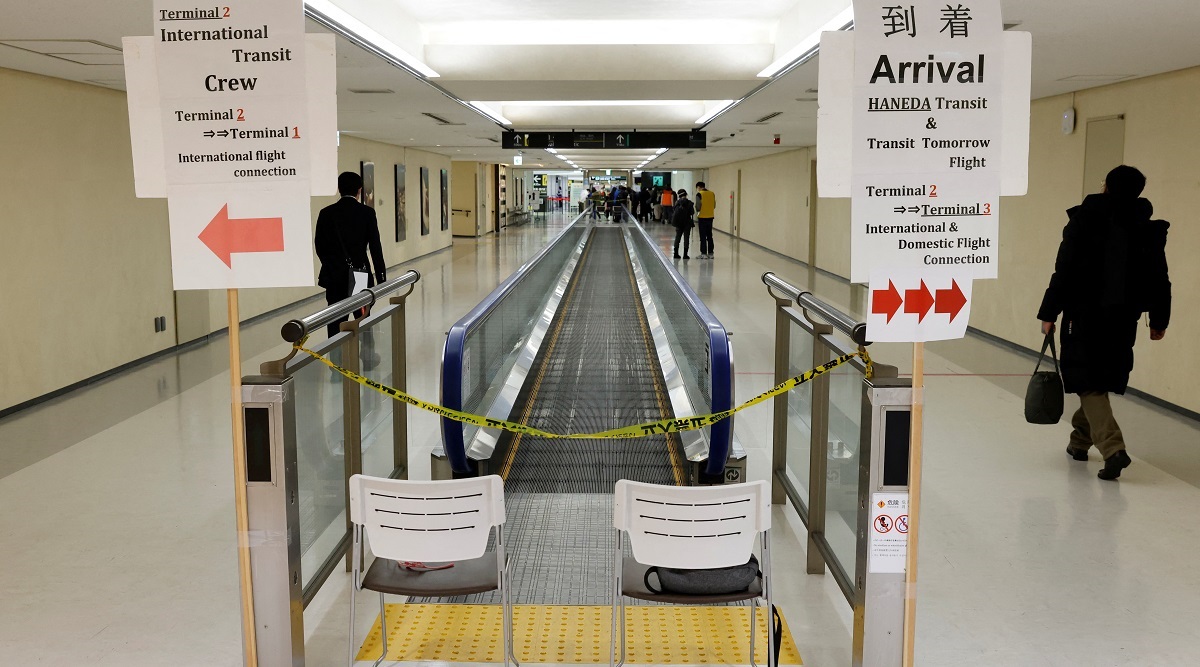 A passenger of a plane from Dalian in China, heads to the coronavirus disease test area, upon his arrival at Narita international airport in Narita, east of Tokyo, Japan. (Reuters)