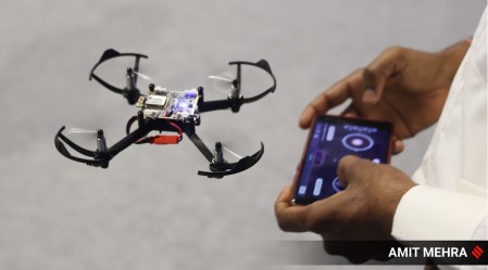 a man flies a drone via remote