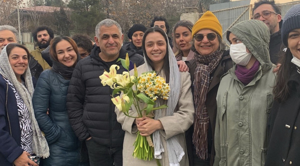 Iranian prominent actress Taraneh Alidoosti, center, holds bunches of flowers as she poses for a photo among her friends after being released from Evin prison in Tehran, Iran, Wednesday, Jan. 4, 2023. (AP)