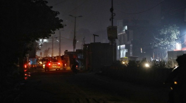When The Indian Express took the route, the road had streetlights, all unlit, erected on the divider, but it was illuminated by the light emitted by vehicles and shops. (Express Photo by Abhinav Saha)