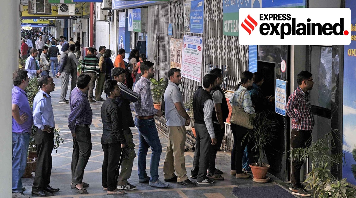 People line up outside an ATM to withdraw their money. Express photo by Jasbir Malhi/File)