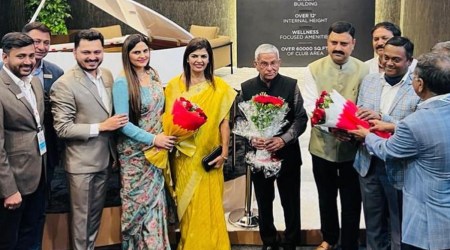 Jaman Patel (centre) welcomes Bharat Boghra (fourth from right) and other dignitaries at his stall at Property Expo and Showcase, 2023, in Rajkot on Friday. (Express photo)