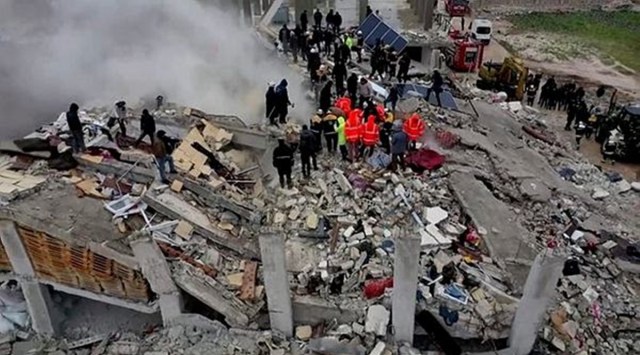 Rescuers search through rubble of collapsed buildings following an earthquake, in the rebel-held town of Sarmada, Syria. (Reuters)