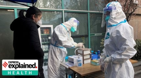 A medical worker in a protective suit registers information for a patient at the entrance to the fever clinic of the Central Hospital of Wuhan, amid of the coronavirus disease (COVID-19) outbreak, in Wuhan, Hubei province, China December 31, 2022.