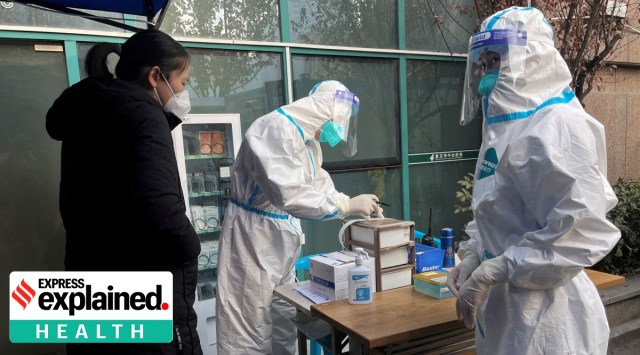 A medical worker in a protective suit registers information for a patient at the entrance to the fever clinic of the Central Hospital of Wuhan, amid of the coronavirus disease (COVID-19) outbreak, in Wuhan, Hubei province, China December 31, 2022.