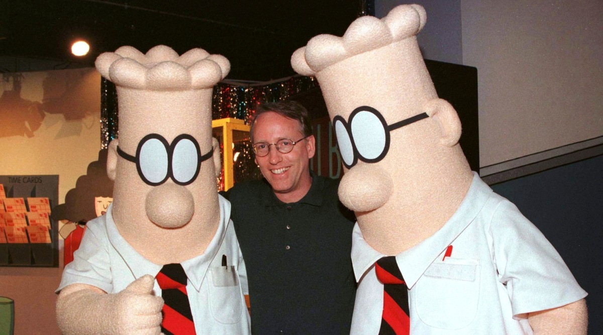 Scott Adams, the creator of "Dilbert", the cartoon character that lampoons the absurdities of corporate life, poses with two "Dilbert" characters (Photo: Reuters/File)