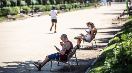 Visitors rest on benches in the shade of trees at Ciutadella Park, a designated climatic refuge, part of Barcelona's Climate Shelter Network (CSN), where residents can take shelter during extreme heat, in Barcelona, Spain, on Aug. 3, 2022. (Bloomberg)