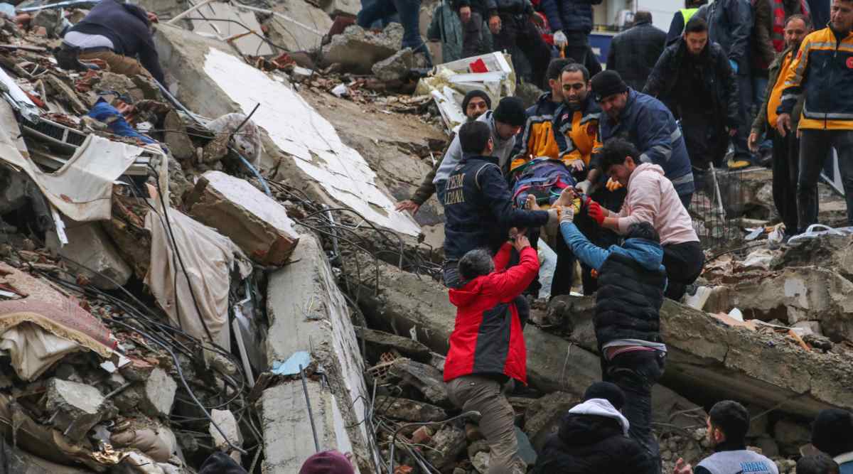 People and emergency teams rescue a person on a stretcher from a collapsed building in Adana, Turkey, Monday, Feb. 6, 2023. (AP/PTI)