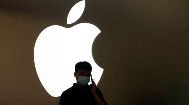 A man talks on a phone in front of an Apple logo outside its store, following the coronavirus disease (COVID-19) outbreak in Shanghai, China, November 7, 2022. REUTERS/Aly Song