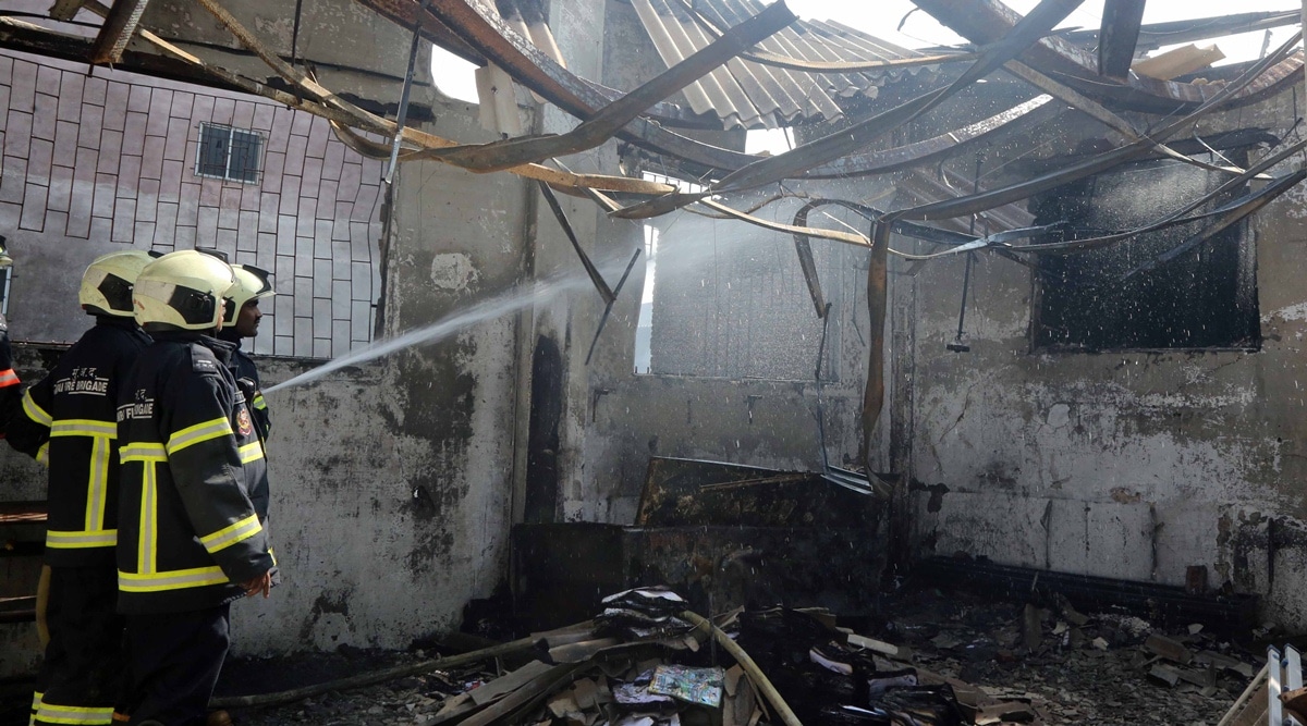 Firefighters try to douse a blaze which broke out in the slums at Kamala Nagar on Wednesday. (Express photo by Ganesh Shirsekar)