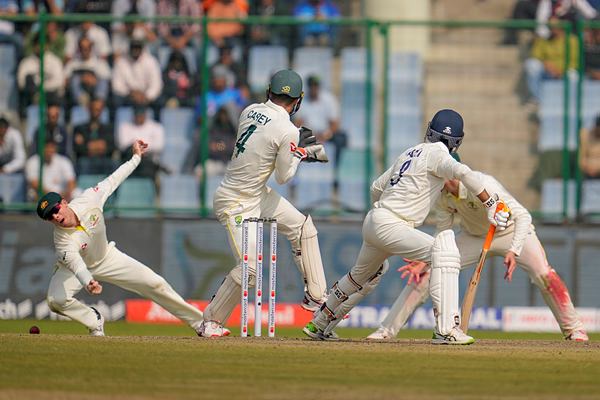 Australia's Steve Smith, left, dives in an attempted to catch out India's Ravindra Jadeja, second right, during the second day of the second cricket test match between India and Australia in New Delhi, India, Saturday, Feb. 18, 2023. (AP Photo/Altaf Qadri)