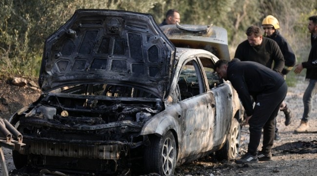 A Palestinian man inspects a burnt car, which residents say was set on fire by Israeli settlers, in Burin village near the West Bank city of Nablus, Saturday, Feb. 25, 2023. Pakistan's press has also been covering Israel’s attack on Syria and Palestine. (AP)