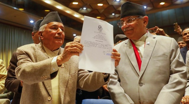 Nepalese Prime Minister Pushpa Kamal Dahal, right, looks on as Ram Chandra Poudel of the Nepali Congress party, left, shows his candidacy papers after filling his nomination to become Nepal's next president. (AP)