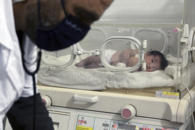 Newborn baby in incubator after getting rescued from rubble