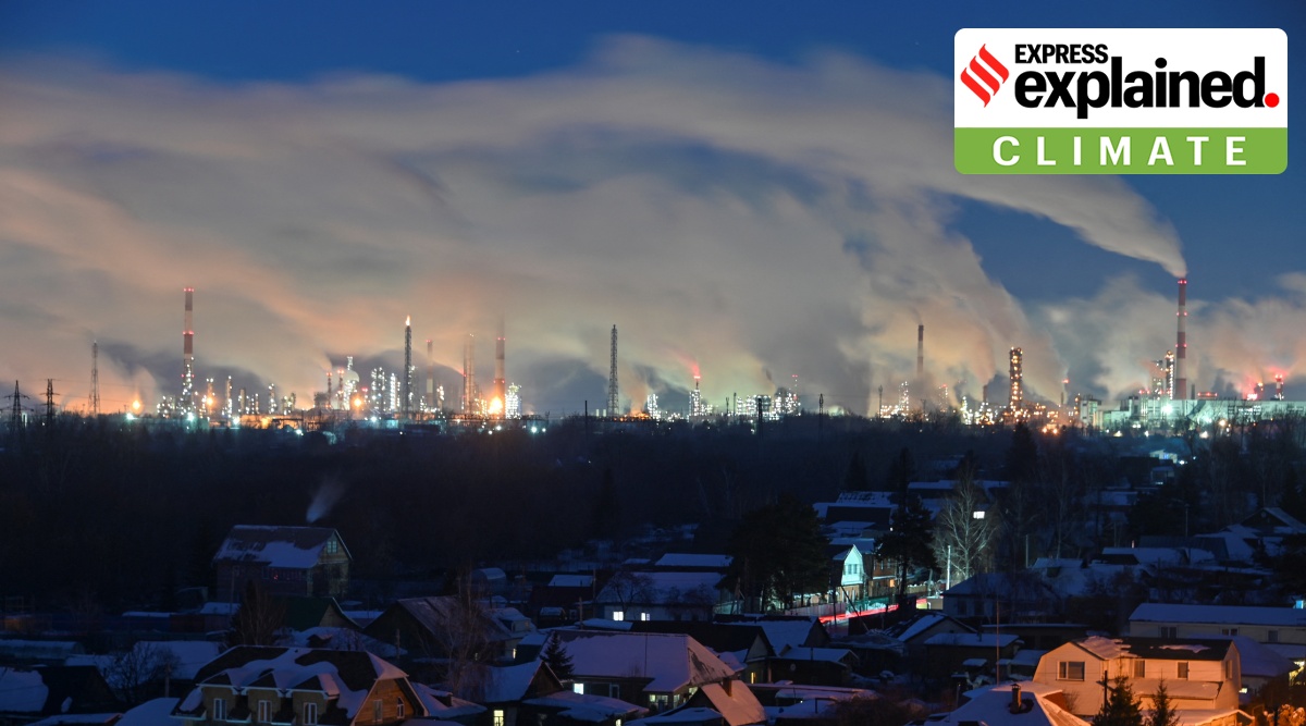 Flue gas and steam rise out of chimneys of an oil refinery in Omsk