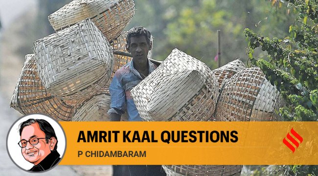 Whatever be the percentage, why does the government not talk about the poor? In pic, a man carrying bamboo baskets on the outskirts of Agartala. (Express file photo by Abhisek Saha)