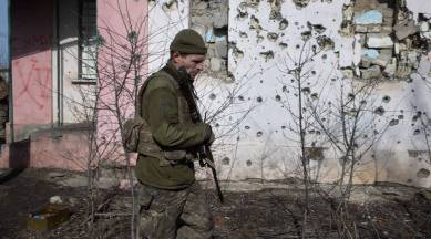 A Ukrainian soldier in Krymske, which was shelled by separatists. (NYT)