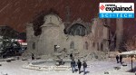 People walk next to a mosque destroyed by an earthquake in Malatya, Turkey