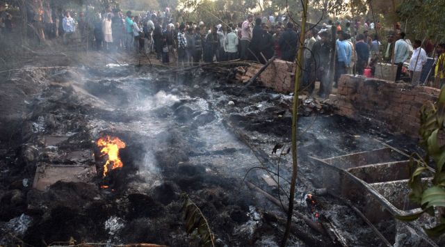 Villagers gather near the rubble of a house during an anti-encroachment drive, in Kanpur Dehat. (PTI)