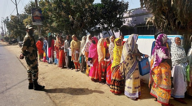 Women queue up outside a polling centre in the Sagardighi Assembly constituency on Monday. (Express Photo)