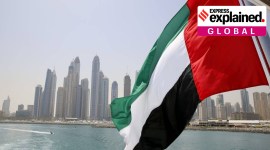 UAE flag flies over a boat at Dubai Marina.