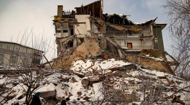 People walk past a collapsed building in Malatya, Turkey, Feb. 7, 2023. (AP/PTI)