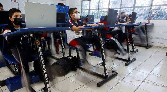 High school students pedal on a bike desk, as part of a program to improve physical health and increase concentration during classes, in San Nicolas de los Garza, Mexico January 18, 2023. (Pic source: REUTERS/Daniel Becerril)