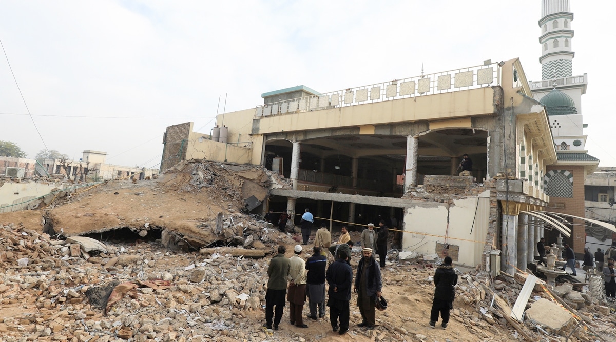 People stand amid the rubble, following a suicide blast in a mosque in Peshawar, Pakistan February 1, 2023. (Reuters)